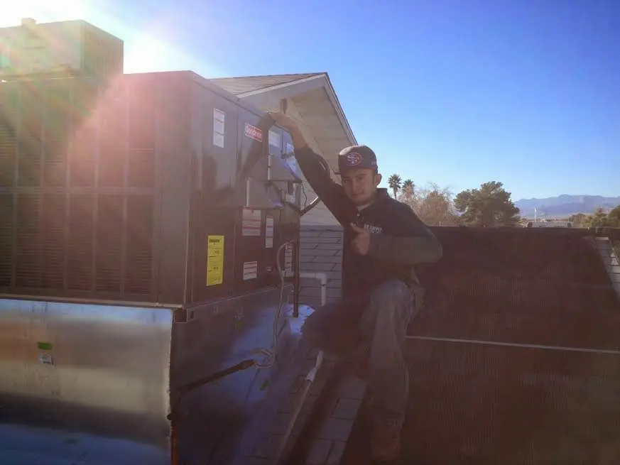 HVAC technician performing Boiler Repair on a rooftop unit in Rodeo